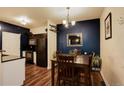 Well-lit dining area with dark wood table set against a painted accent wall at 2430 W 82Nd Pl # 2F, Westminster, CO 80031