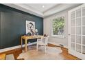 Stylish home office with wood floors, a chic desk, and a large window for natural light at 3881 Zenobia St, Denver, CO 80212