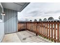 Balcony features a wood fence, grey siding and space to enjoy the outdoors at 7260 S Gaylord St # E26, Littleton, CO 80122