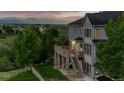 Spacious outdoor deck with stone pillars offers stunning views of the surrounding landscape at 3041 Starling Ct, Castle Rock, CO 80109