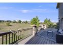Outdoor deck area with wooded railings overlooking the lush green lawns of the surrounding community at 3041 Starling Ct, Castle Rock, CO 80109