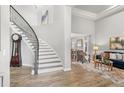 Elegant foyer showcases a curved staircase and flows into the dining and living areas at 3041 Starling Ct, Castle Rock, CO 80109