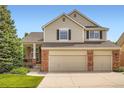 Attractive two-story house featuring a two-car garage, brick accents, and a well-maintained front yard at 2561 Cactus Bluff Pl, Highlands Ranch, CO 80129