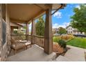 Inviting front porch with comfortable seating, overlooking the street at 7932 E 49Th Pl, Denver, CO 80238