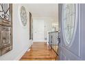 Inviting entryway features gleaming hardwood floors, decorative wall art, and a stylish front door at 2085 S Deframe St, Lakewood, CO 80228