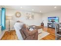 Cozy living room featuring a plush recliner, modern decor, and a mounted television at 2085 S Deframe St, Lakewood, CO 80228