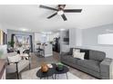 Open concept living room and kitchen boasting recessed lighting and a modern ceiling fan at 1109 Ash Ct, Fort Lupton, CO 80621