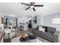 Bright, open-concept living and dining area with hardwood floors and modern furnishings at 1109 Ash Ct, Fort Lupton, CO 80621