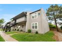 Two-story apartment building featuring balconies, green lawn, and mature trees on a clear day at 7110 S Gaylord St # O7, Centennial, CO 80122