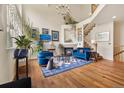 Bright living room featuring vaulted ceilings, a fireplace, hardwood floors, and tasteful furnishings at 18489 E Columbia Cir, Aurora, CO 80013