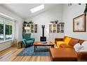 Bright living room with vaulted ceilings, skylight, hardwood floors and contemporary furnishings at 2390 N Springwood Ct, Lafayette, CO 80026
