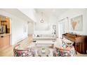 Sunlit living room featuring a cozy sofa, piano, and stylish floral armchairs at 3970 Longwood Ave, Boulder, CO 80305