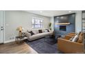 Modern living room with stylish furniture, fireplace, and ample natural light from a large window at 6635 S Sherman St, Centennial, CO 80121