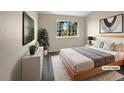 Cozy bedroom featuring a large window with lush greenery and a minimalist modern design style at 2418 W 82Nd Pl # D, Westminster, CO 80031
