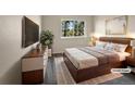 Staged bedroom featuring a plush bed, modern furniture, and a bright window view at 2418 W 82Nd Pl # D, Westminster, CO 80031