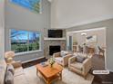Bright living room with stone fireplace, large windows, and an open floor plan to the dining area at 2418 W 82Nd Pl # D, Westminster, CO 80031