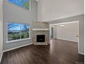 Bright and airy living room with a stone fireplace, hardwood floors and view to dining room at 2418 W 82Nd Pl # D, Westminster, CO 80031