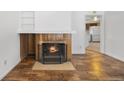 Charming living room featuring a fireplace, wood flooring, and neutral wall paint at 395 Raspberry Ln, Monument, CO 80132