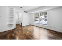 Bright room featuring built-in shelves, hardwood-style floors, and a sunny window at 395 Raspberry Ln, Monument, CO 80132