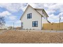 Striking two-story home with a modern design, white siding, and black framed windows at 3890 N Cook St, Denver, CO 80205