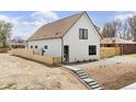 Stylish two-story home with white siding, a fenced yard, and modern design at 3890 N Cook St, Denver, CO 80205