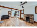 Spacious living room with hardwood floors, a brick fireplace, and a comfortable seating area at 4556 Decatur St, Denver, CO 80211