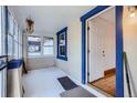 Bright sunroom featuring ample windows, neutral walls, and a cozy, welcoming atmosphere at 4556 Decatur St, Denver, CO 80211