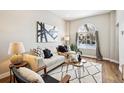 Living room features hardwood floors, large windows and comfy seating at 1342 Lipan St, Denver, CO 80204