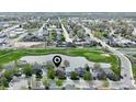 Aerial shot showcasing the home's location near a pond, golf course, and residential neighborhood at 293 Wagonwheel Dr, Fort Lupton, CO 80621