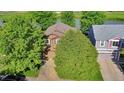 Overhead view of a brown, two-story home with mature trees and a well-maintained yard, showcasing its curb appeal at 293 Wagonwheel Dr, Fort Lupton, CO 80621