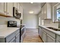 Bright kitchen featuring new stainless steel appliances, stone countertops and ample cabinet space at 8418 Ames, Arvada, CO 80003