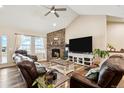 Comfortable living room with vaulted ceilings, stone fireplace, and lots of natural light at 39200 E 148Th Ct, Keenesburg, CO 80643