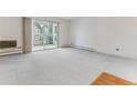 Spacious living room featuring wall-to-wall carpeting and a sliding glass door at 620 S Alton Way # 5B, Denver, CO 80247