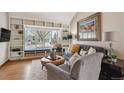 Cozy living room featuring built-in shelves, a window seat, and stylish decor at 6836 Edgewood Way, Highlands Ranch, CO 80130