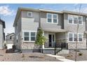 Beautiful two-story townhome featuring manicured landscaping, stone accents, and a cozy front porch at 1422 Hudson Pl, Longmont, CO 80501