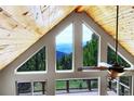Spacious living room features wood ceilings, many windows, and spectacular views at 1176 Raven Ridge Rd, Idaho Springs, CO 80452
