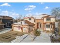 Two-story home with a three-car garage and a snow-covered yard. American flag displayed at 8932 Tuscany Ln, Highlands Ranch, CO 80130