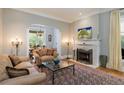 Cozy living room featuring a fireplace, plush seating, and an adjacent dining area at 728 N Ogden St, Denver, CO 80218