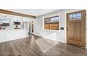 Open-concept living area featuring luxury vinyl plank floors, large windows, and a view into the modern kitchen at 3437 N Jackson St, Denver, CO 80205