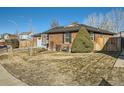 Beautiful brick home with a green lawn, mature trees, and an inviting front entrance at 438 N 11Th Ave, Brighton, CO 80601