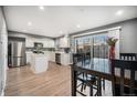 Bright kitchen with white cabinets, stainless steel appliances, and dining area at 8624 Mariposa St, Thornton, CO 80260