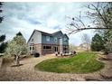 Lovely backyard with a patio, lush lawn, mature trees, and professional landscaping, perfect for outdoor living at 15960 E Aberdeen Ave, Centennial, CO 80016