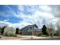 Beautiful two-story home with a three car garage, brick and siding exterior, and a well-maintained lawn at 15960 E Aberdeen Ave, Centennial, CO 80016