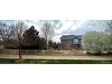 Exterior view showcasing a fenced yard and well-kept lawn surrounding the property at 15960 E Aberdeen Ave, Centennial, CO 80016