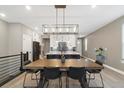 Spacious dining room showcasing an open concept and modern lighting fixtures at 17233 W 93Rd Pl, Arvada, CO 80007
