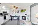 Inviting dining area features a fireplace and modern ceiling fan at 1845 Kendall St # 325D, Denver, CO 80214