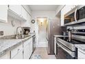 Well-lit kitchen with stainless steel appliances and granite countertops at 1845 Kendall St # 325D, Denver, CO 80214