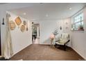 Finished basement area with neutral carpet, natural light, and decor at 12920 W 24Th Pl, Golden, CO 80401