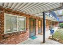 Private apartment entrance with brick facade, covered walkway, and outdoor access at 155 S Pennsylvania St # 101, Denver, CO 80209