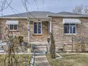 Brick Ranch home with mature trees and walkway at 1333 Hanover St, Aurora, CO 80010